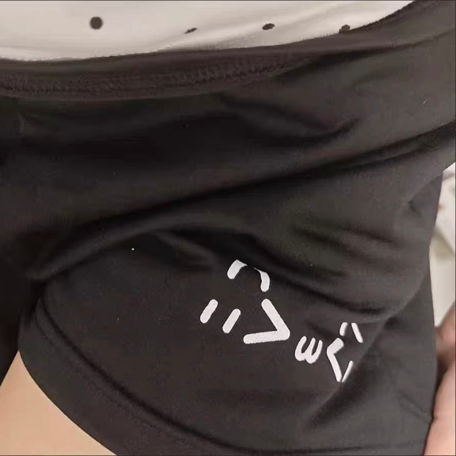Black pants with a white logo on the knee area.