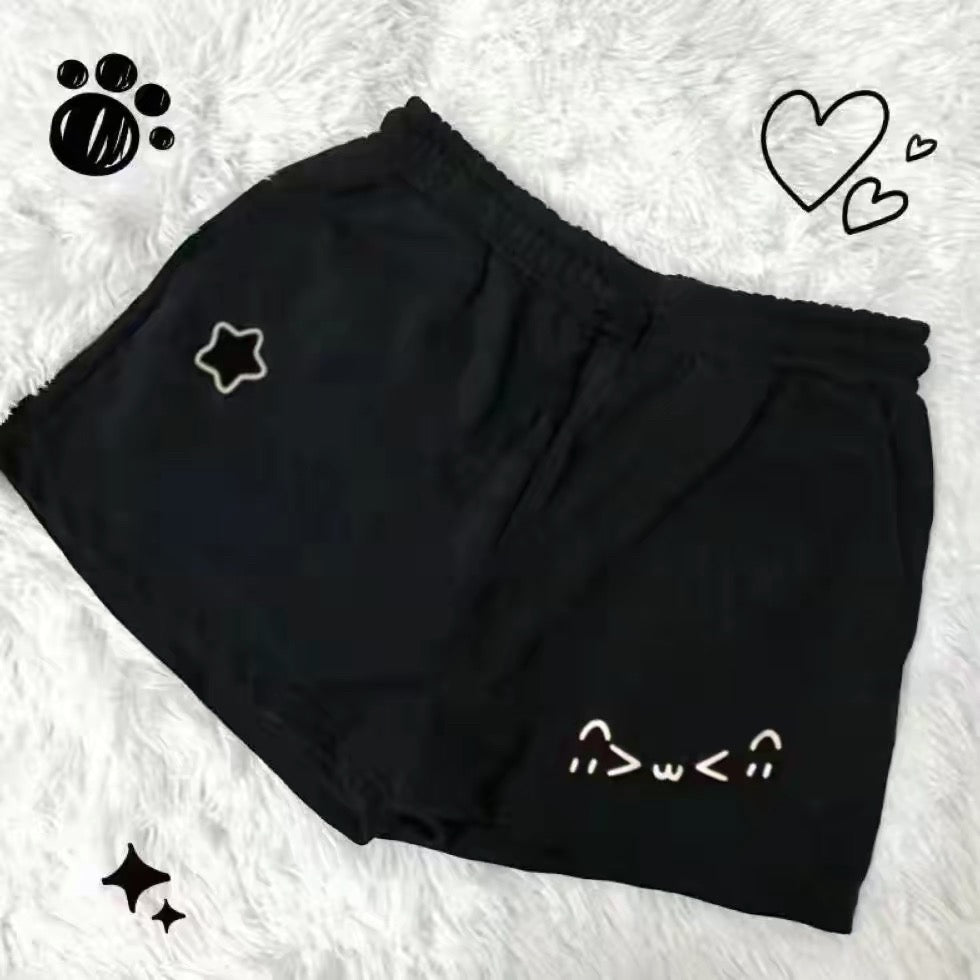 Black shorts with white designs on a textured white background