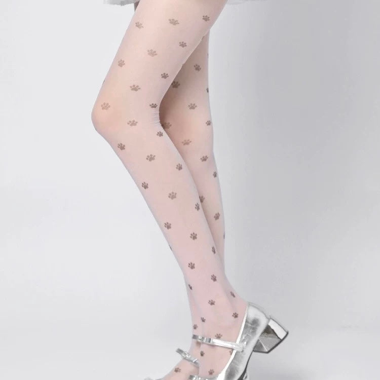 Sheer tights with paw print pattern worn by a person on a light gray background