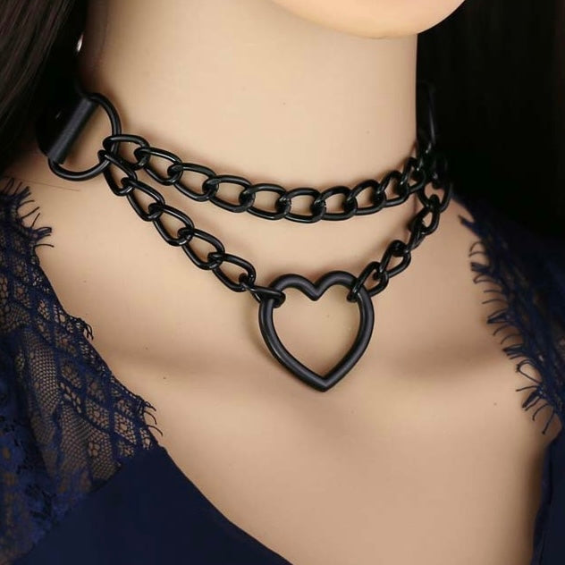 Black chain necklace with heart-shaped clasp on a mannequin