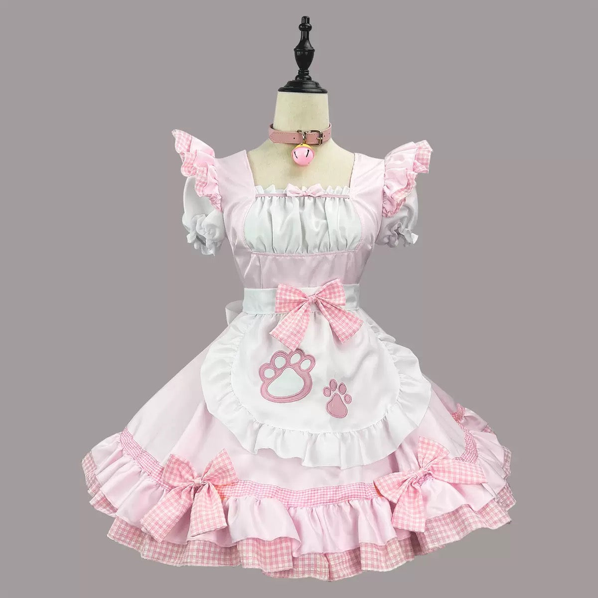 Pink and white dress on a mannequin against a gray background