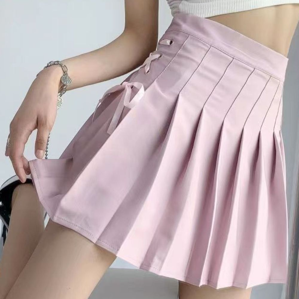 Femboy in a pink lace up side pleated skirt
