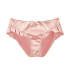 Pink satin underwear with lace trim on a white background