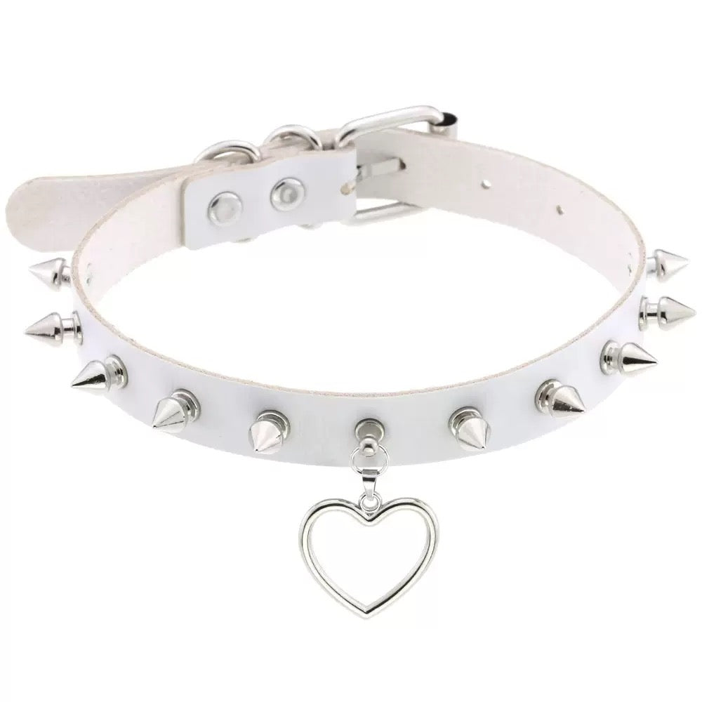 White leather choker with silver spikes and a heart pendant on a white background