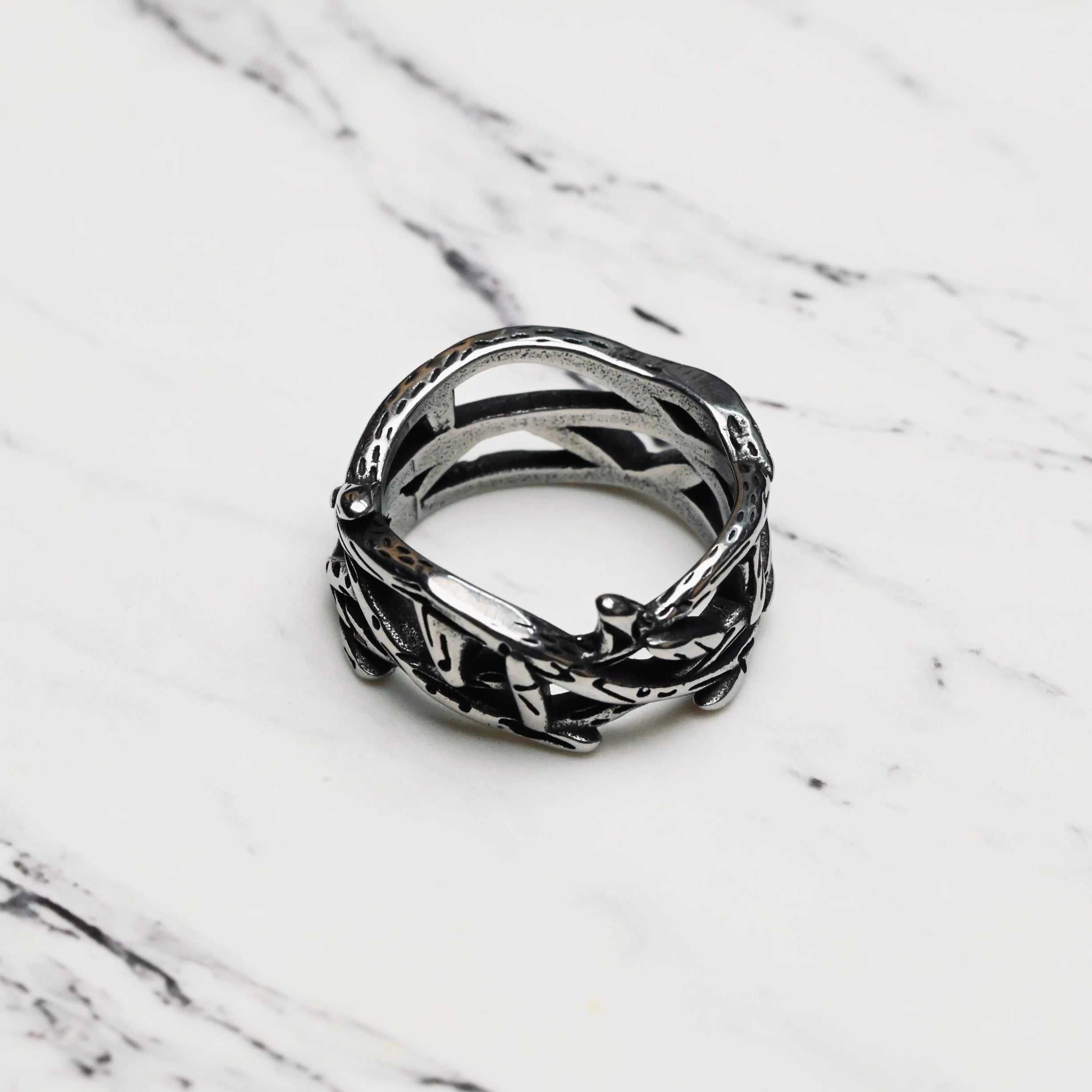 Silver retro thorns stainless steel ring on a marble surface