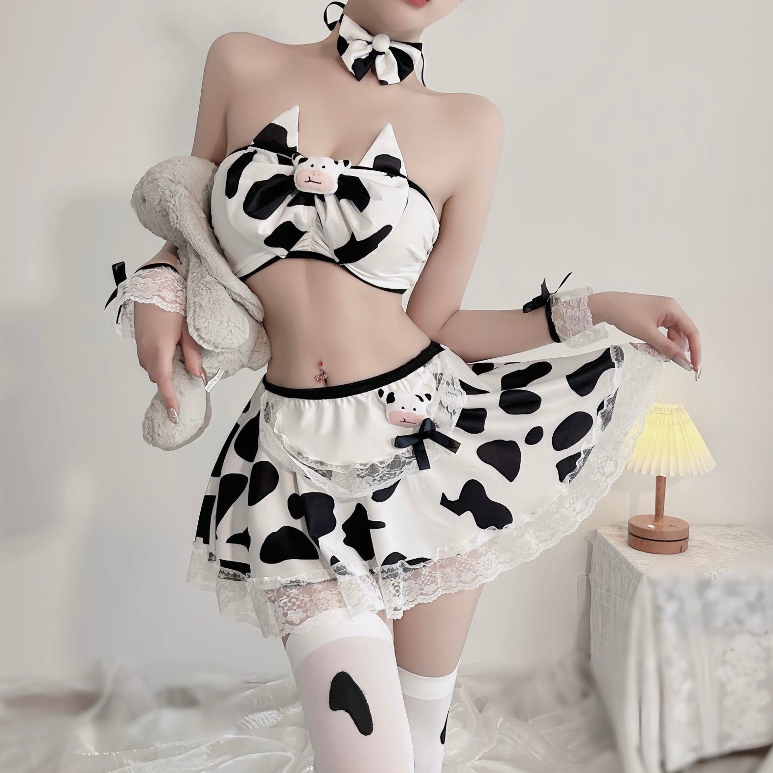 Person wearing a cow print outfit with a white background