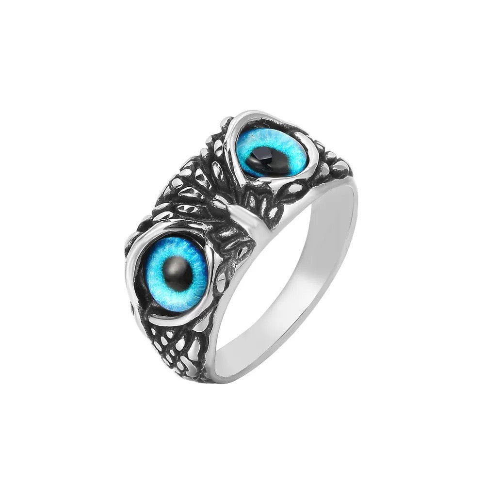 Silver ring with blue eye design on a white background