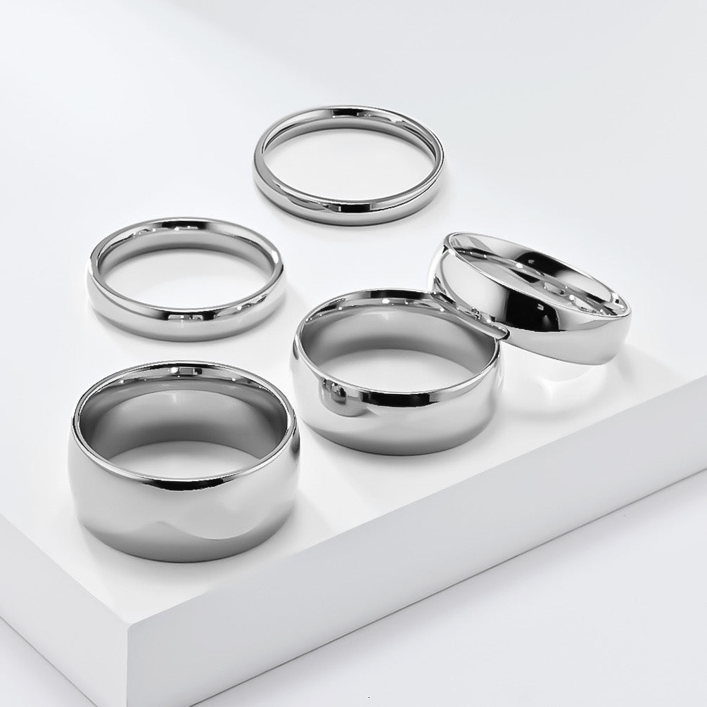 Set of silver minimalism stainless steel ring band on a white surface