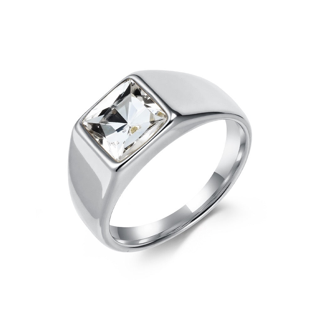 Silver ring with a clear gemstone on a white background