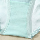 Close-up of light blue fabric with white trim on a beige surface