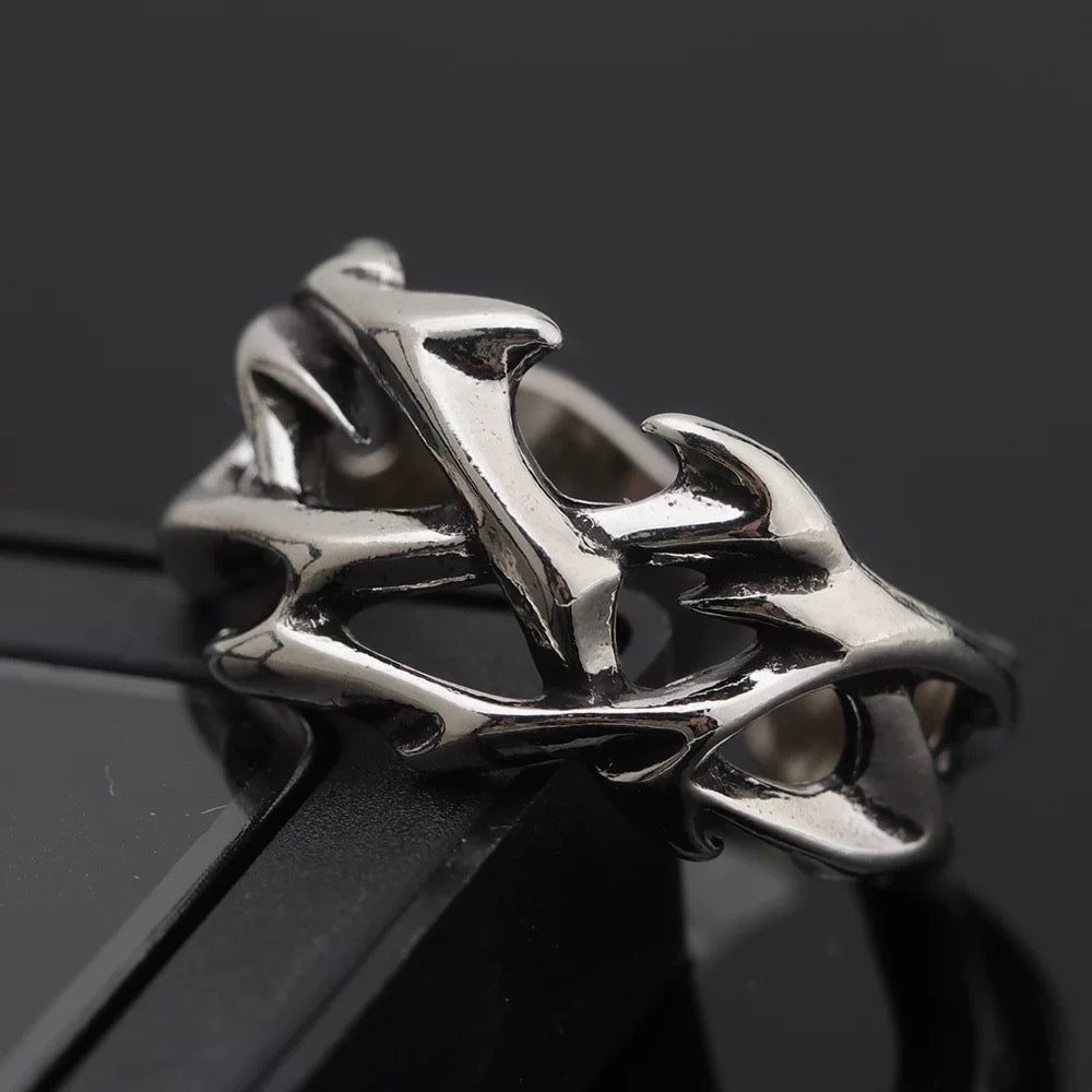 Silver thorny vine stainless steel ring with intricate design on a black background