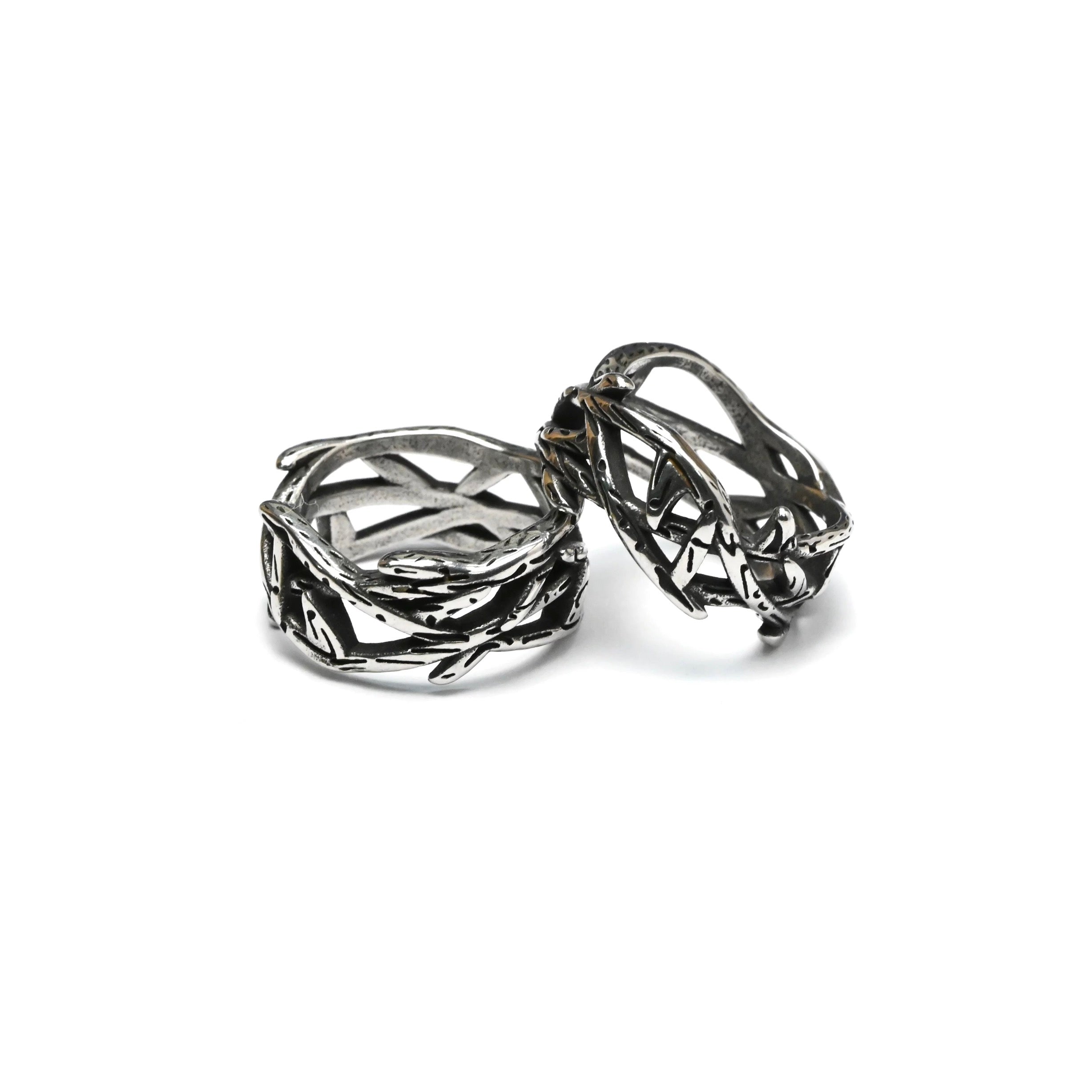Pair of retro thorns stainless steel rings on a white background