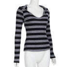 Black and gray striped long-sleeve top on a mannequin against a white background