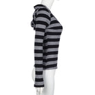 Mannequin wearing a black and gray striped sweater on a white background