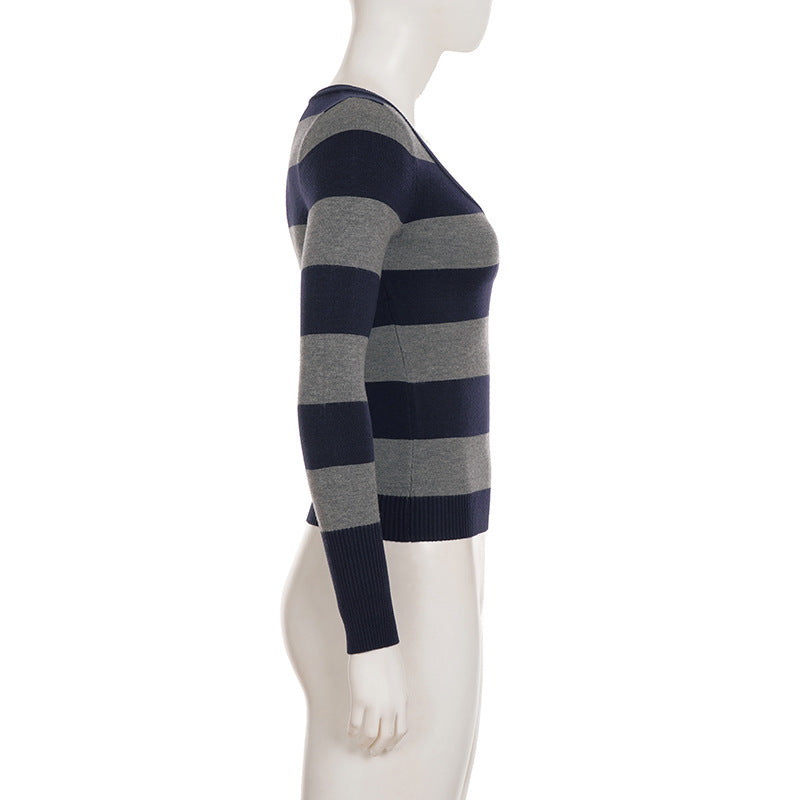 Mannequin wearing a black and gray striped sweater on a white background