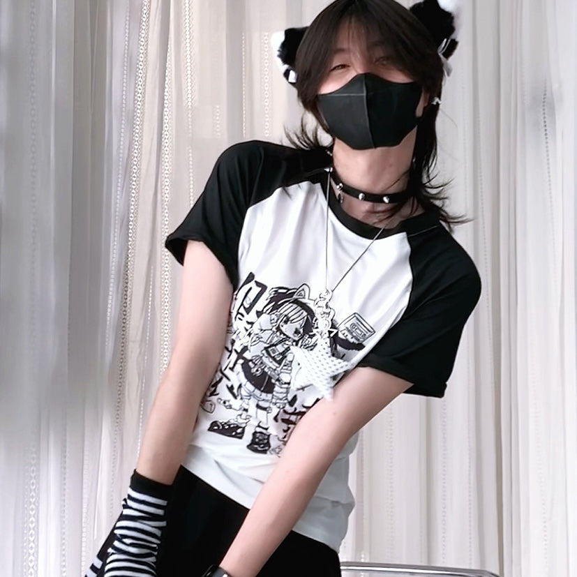 Person wearing a black and white graphic t-shirt with a mask and striped socks against a white curtain background
