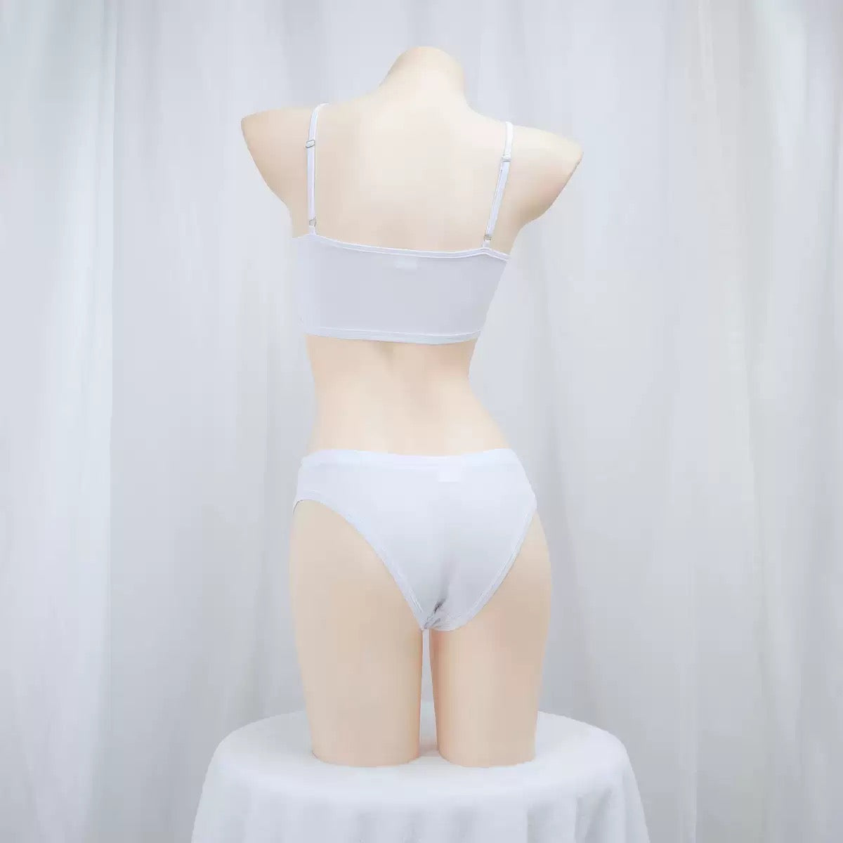 Mannequin wearing a light gray bra and panties set against a white background