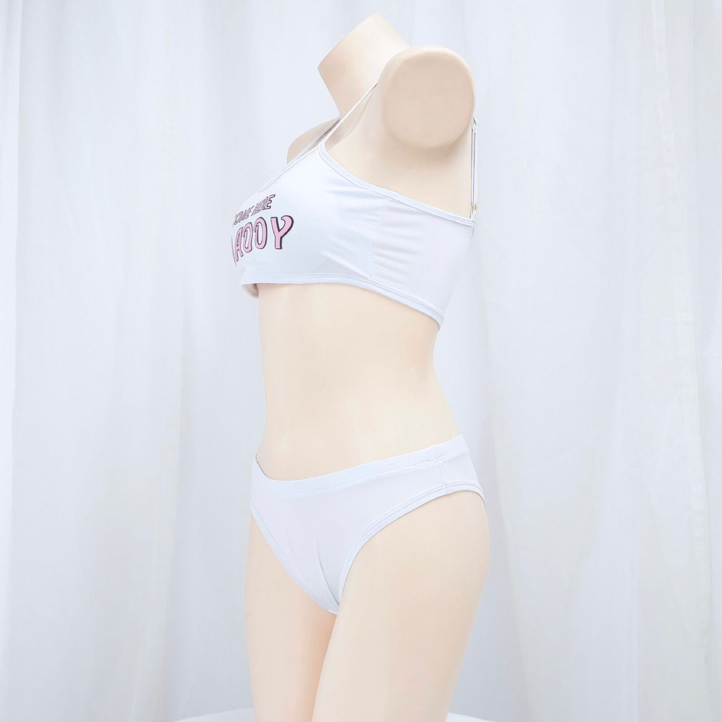 White bikini set on a mannequin against a white background