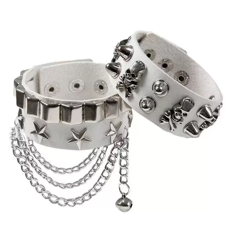 White gothic skull leather bracelets with silver studs and chains on a white background