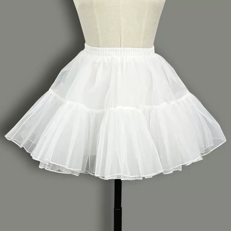 White petticoat on a mannequin against a gray background
