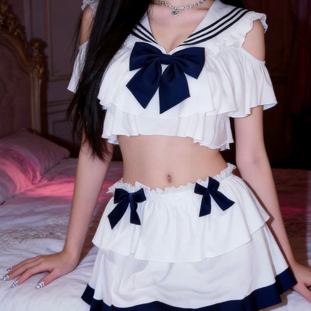 Person wearing a white and blue sailor uniform with a plain background