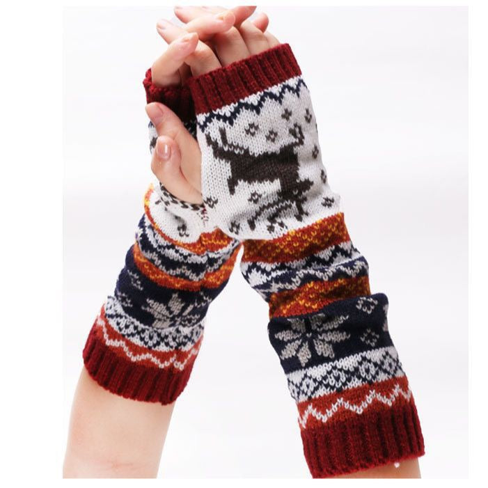 Knitted arm warmers with reindeer pattern on a white background