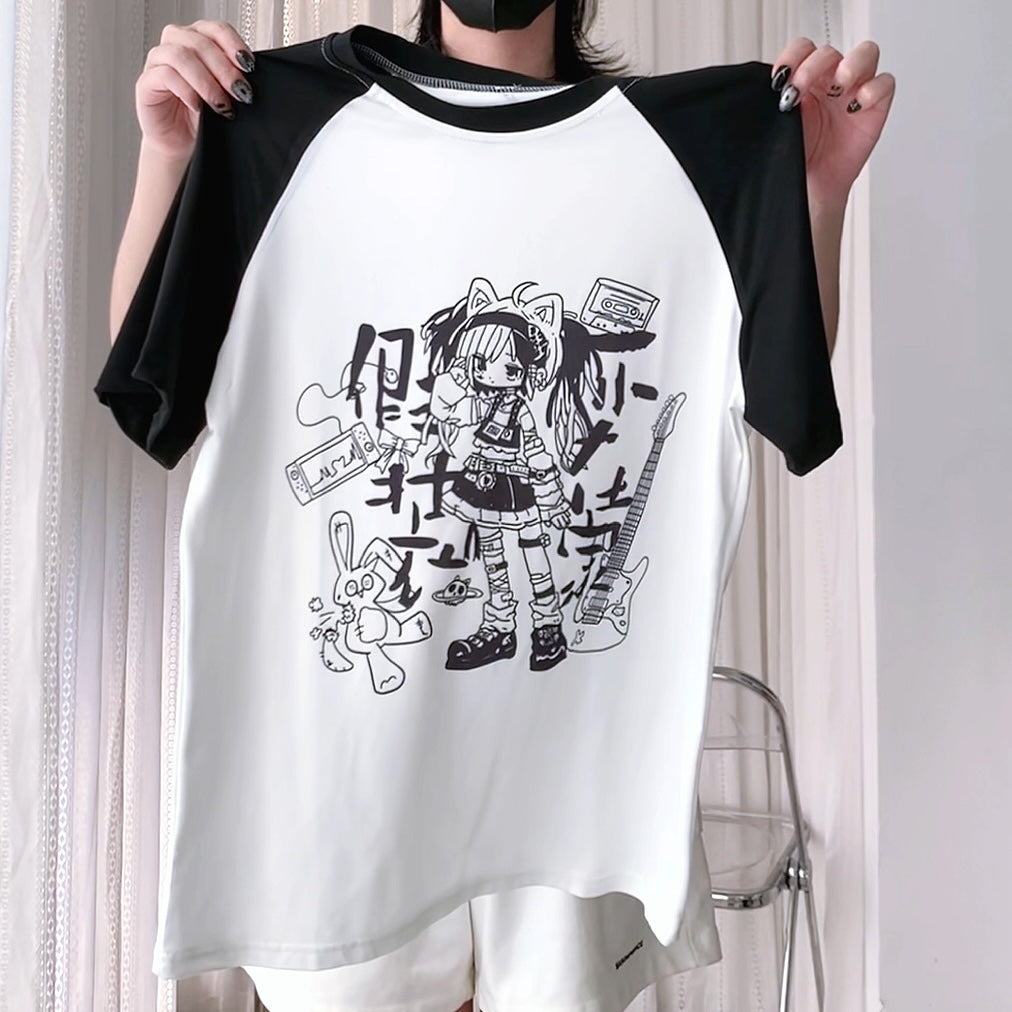 Person holding a white baseball shirt with black sleeves featuring a graphic design.