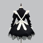 Black and white gothic maid dress on a mannequin against a gray background back