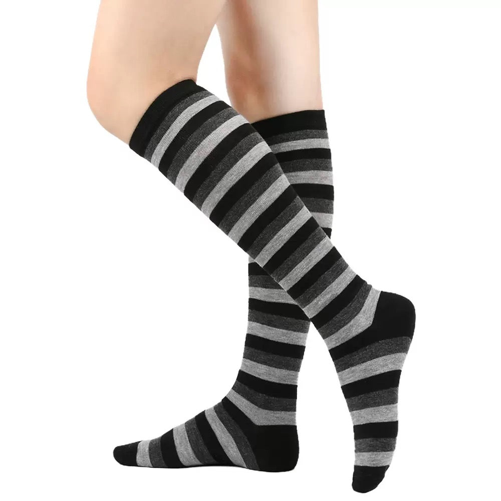 Black and gray striped knee-high socks on a white background