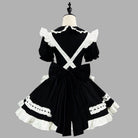 Black and white maid costume on a mannequin against a gray background