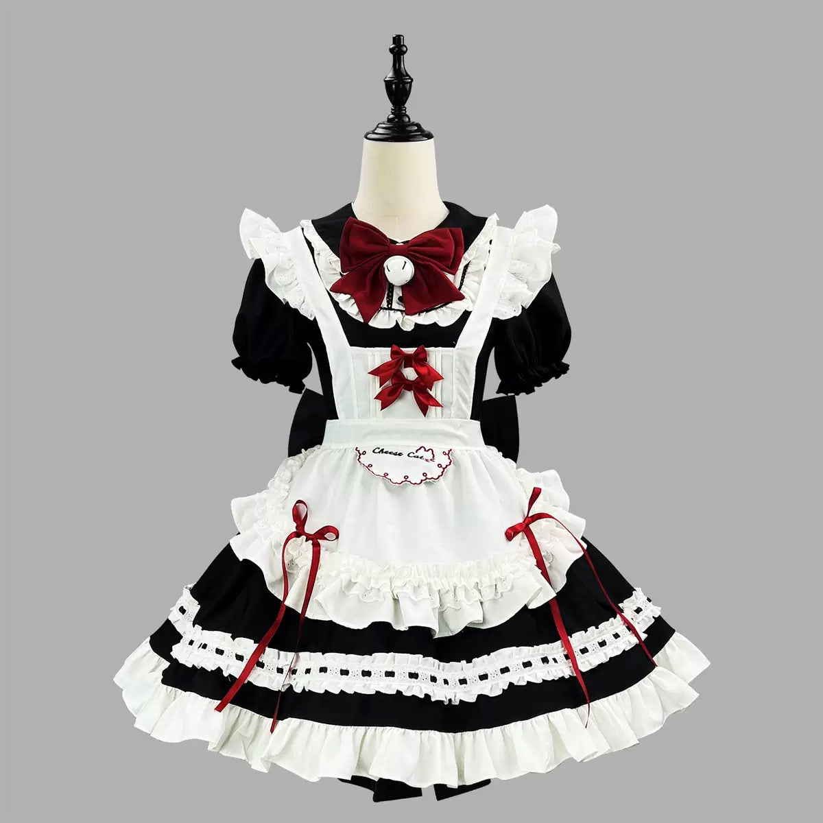 Lolita fashion dress with black and white color scheme on a mannequin against a gray background