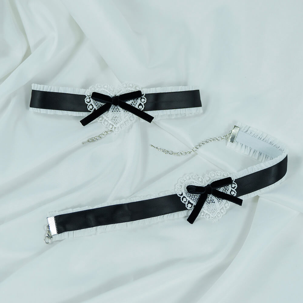 Two black satin sweet lolita maid choker with lace detailing on a white fabric background