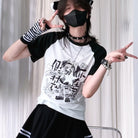 Person wearing a black and white baseball shirt with graphic design, posing against a light curtain background.