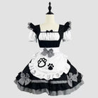 Black and white dress with bow details and paw print design on a mannequin against a light gray background.