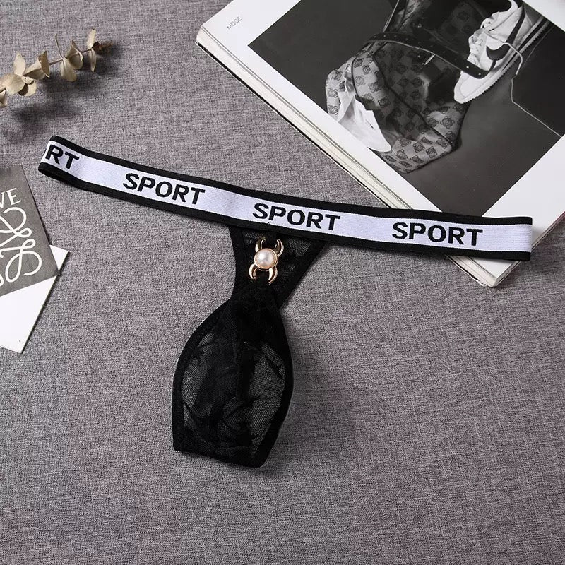 Black choker with 'SPORT' text on a gray surface