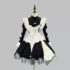 Black and white gothic maid dress on a mannequin against a gray background