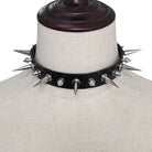 Black leather choker with spikes on a mannequin bust.