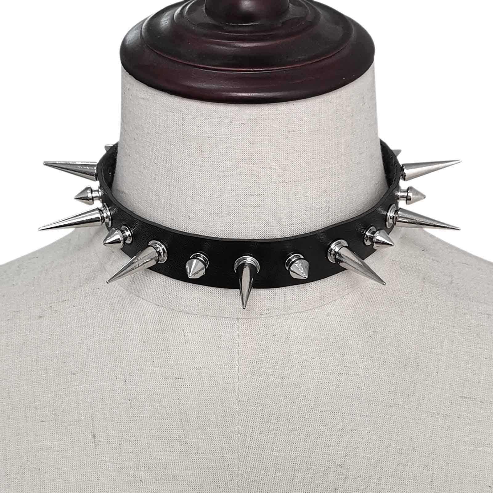 Black leather choker with spikes on a mannequin bust.