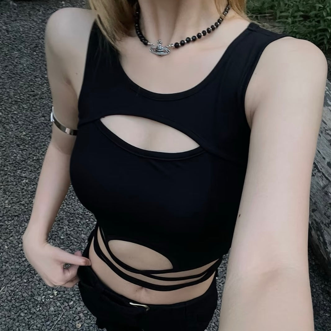 Person wearing a black cut-out swimsuit with a blurred background