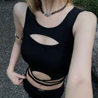 Person wearing a black cut-out swimsuit with a blurred background