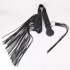 Black leather strap with tassel on a white background