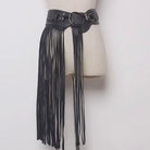 Black fringe leather belt on a mannequin against a white background