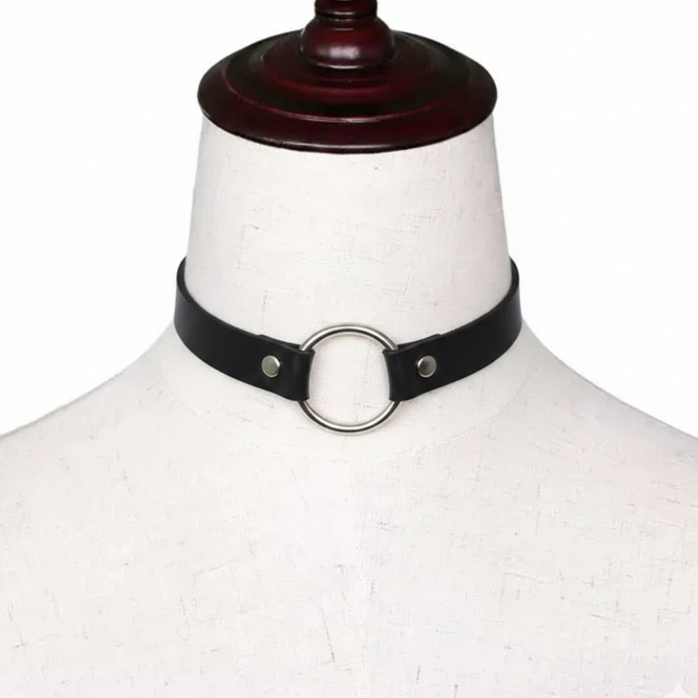 Black leather choker with silver ring on a mannequin head against a white background