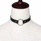 Black leather choker with silver ring on a mannequin head against a white background