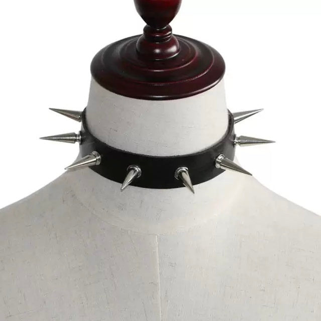 Black leather choker with spikes on a mannequin against a white background