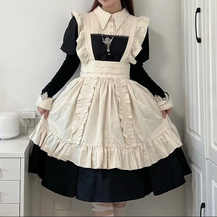 Person wearing a black and white dress with ruffled details in a room.