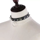 Black leather choker with heart-shaped pendant on a mannequin.