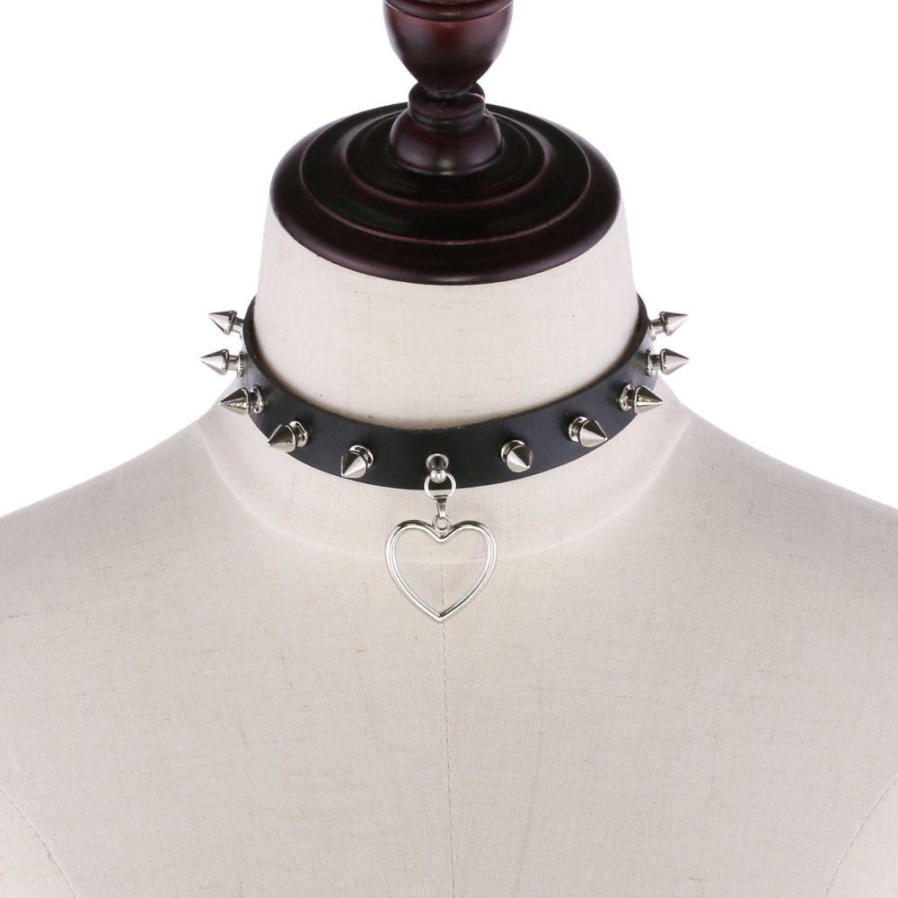 Black leather choker with silver heart pendant on a mannequin.
