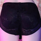 Black lace underwear on a pink background