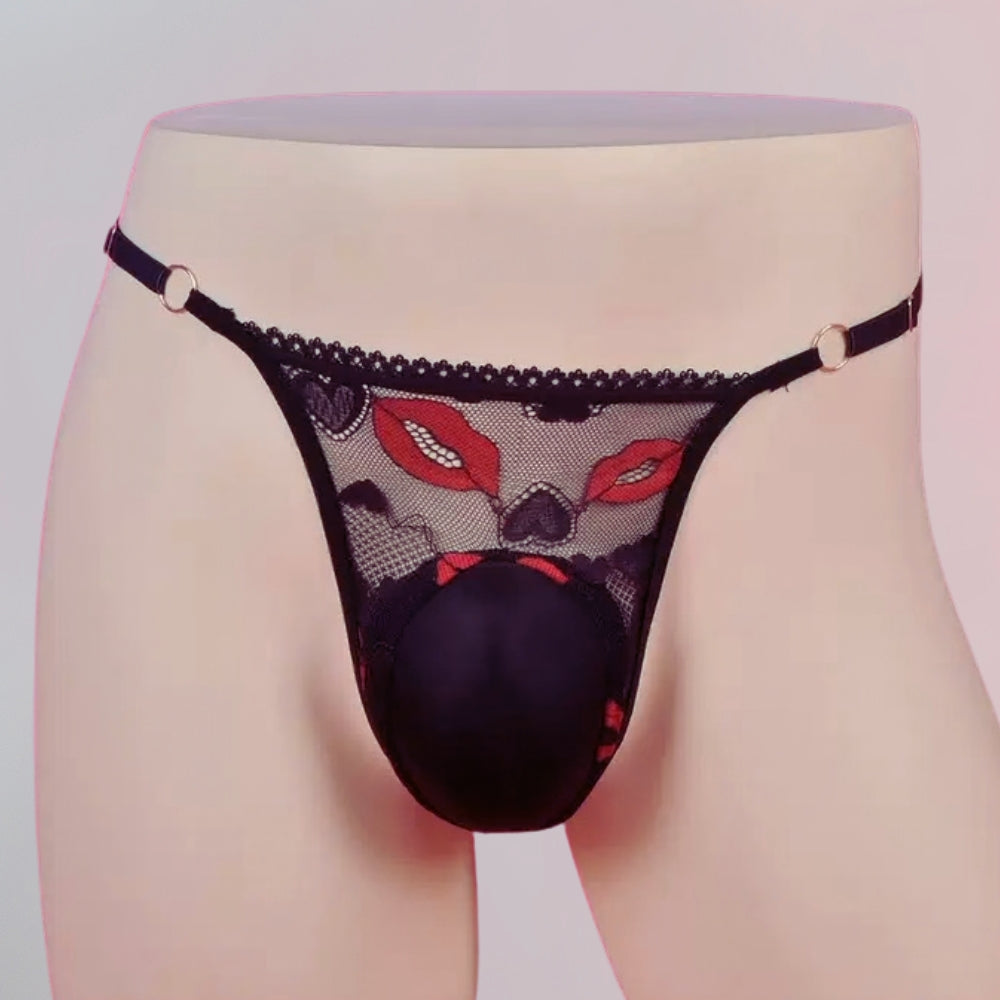 Black lace lingerie with red accents on a mannequin against a light background